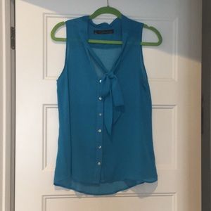 Blue sleeveless button down with tie neck